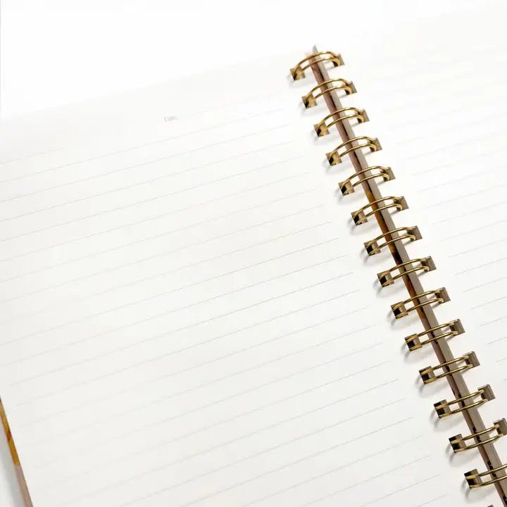 Artichoke notebook with blank lined pages and a spiral binding, open to show interior layout.