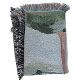 Orchard woven blanket featuring a tree design with a fringed edge in various colors.