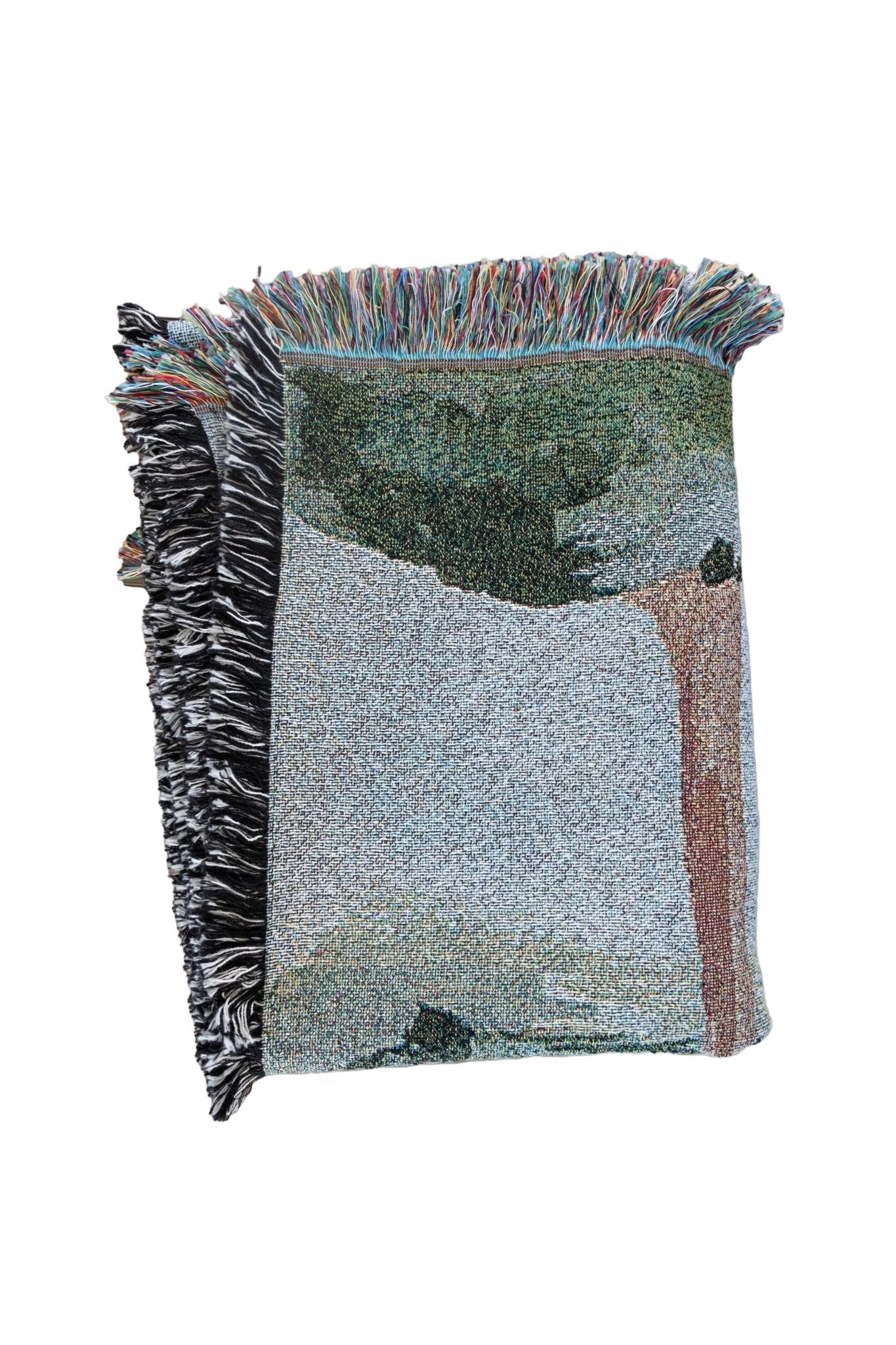 Orchard woven blanket featuring a tree design with a fringed edge in various colors.