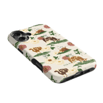 Pasture iPhone case featuring floral and cow illustrations on a cream background with black edges.