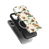 Pasture iPhone case featuring floral and animal designs in earthy tones, layered over a black phone case.