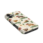 Pasture iPhone case featuring floral patterns and illustrations of cows in earthy tones on a light background.