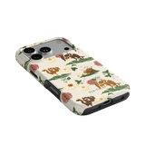 Pasture iPhone case featuring a floral and animal design in earthy tones, angled to show the camera cutout.