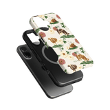 Pasture iPhone case featuring floral and animal designs in earthy tones, stacked with a black phone case.