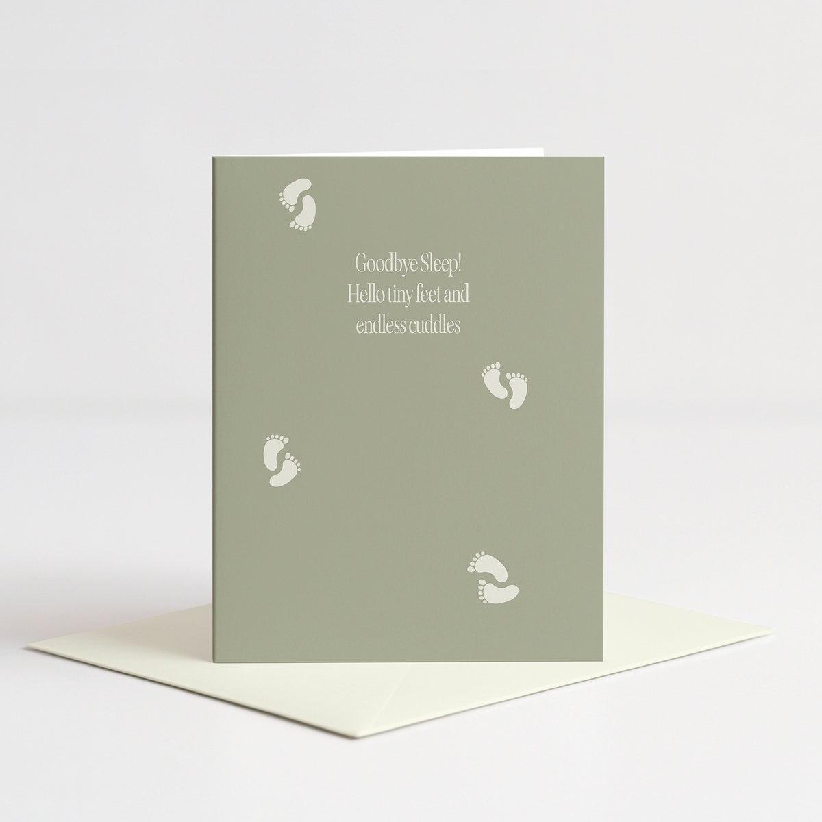 Tiny Feet Baby Card standing on a natural cream envelope