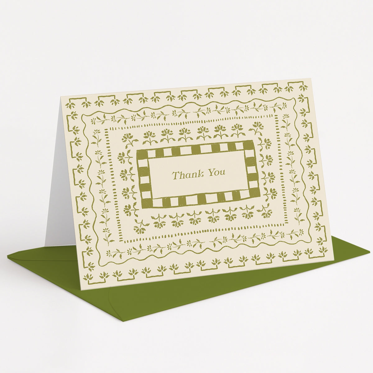 Curio Thank You Card by Pen+Pillar standing on a green envelope