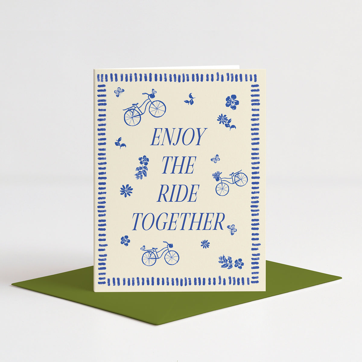 Bike Ride Wedding Card standing on a green envelope