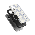 Riviera iPhone case featuring a floral design in blue on a white background, layered over a black case.