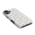 Riviera iPhone case featuring a floral pattern in blue on a cream background with black edges.