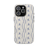 Riviera iPhone case featuring a floral pattern in blue on a cream background with a textured finish.