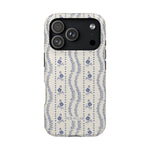 Riviera iPhone case featuring a floral pattern in blue and cream with a sleek design and camera cutout.