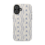 Riviera iPhone case featuring a floral pattern in blue on a cream background with a black edge.