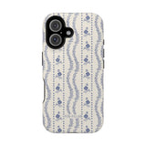 Riviera iPhone case featuring a floral pattern in blue on a cream background with black edges.