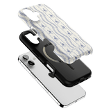 Riviera iPhone case featuring a floral design in blue on a white background, layered over a black and white phone.