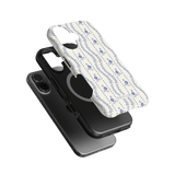 Riviera iPhone case featuring a floral pattern in blue on a white background, layered over a black phone case.