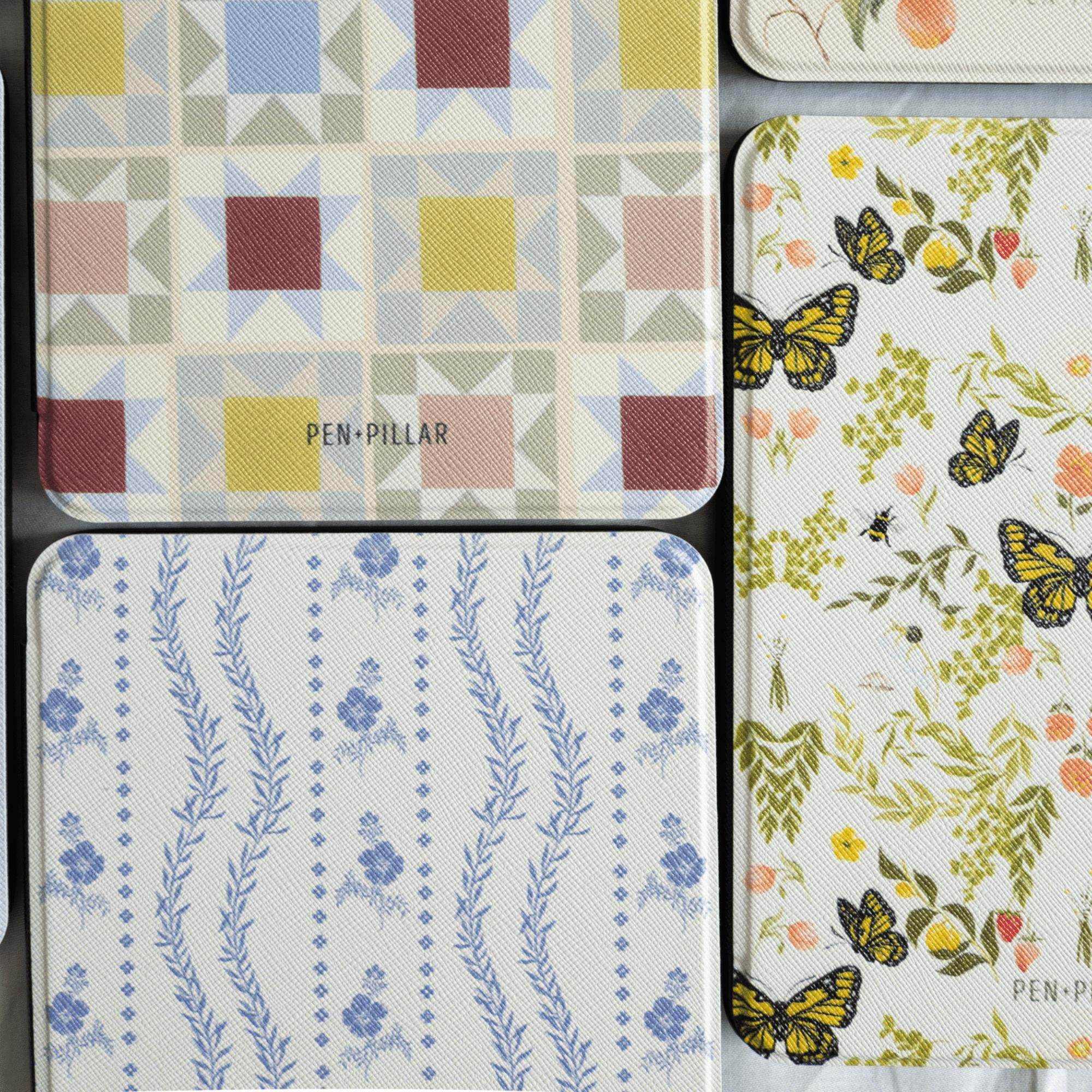 Riviera Kindle case featuring a floral design with butterflies and a blue floral pattern on a textured background.