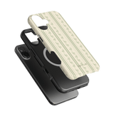 Roselle iPhone case featuring a floral pattern on a cream background, layered over two black phone cases.