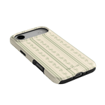 Roselle iPhone case with a cream and green floral pattern, angled view showing button and port cutouts.