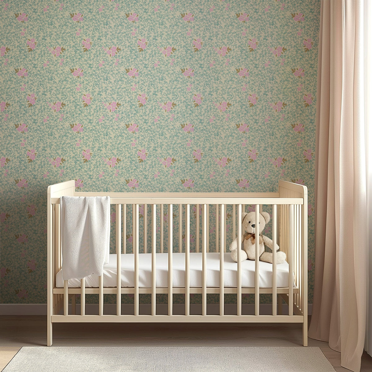 Light wood crib against Roxanne floral wallpaper featuring pink flowers and green vines by Pen and Pillar.