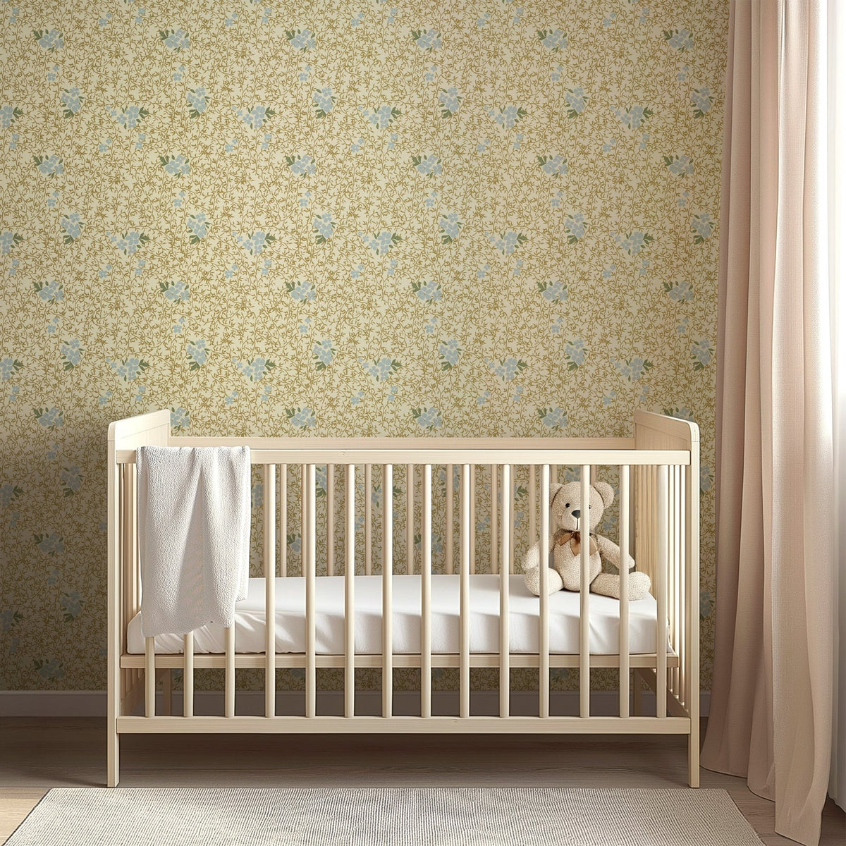 Light wood crib against Roxanne by Pen and Pillar wallpaper featuring a yellow and blue floral pattern.
