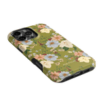 Scarlett iPhone case featuring a floral design with white and pink flowers on a green background.
