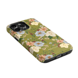 Scarlett iPhone case featuring a floral design with white and pink flowers on a green background.