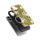 Scarlett iPhone case featuring a floral design with green background, layered over a black phone case.