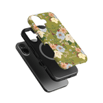 Scarlett iPhone case featuring a floral design in pastel colors on a green background, layered over a black phone.
