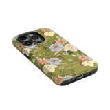 Scarlett iPhone case featuring a floral design with pastel flowers on a green background, angled to show the camera cutout.