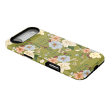 Scarlett iPhone case featuring a floral design with pink, blue, and yellow flowers on a green background.