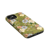 Scarlett iPhone case featuring a floral design with pastel flowers on a green background, angled to show camera cutout.