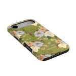 Scarlett iPhone case featuring a floral design with green background and black edges, angled view showing ports.
