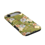 Scarlett iPhone case featuring a floral design with green background and black edges, angled view showing ports.