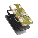 Scarlett iPhone case featuring a floral design with green background and colorful flowers, shown on a black phone.