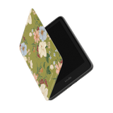 Scarlett Kindle case with a floral design in green, partially open, displaying the Kindle device inside.