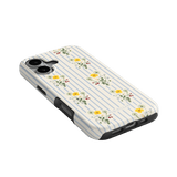 Springtide iPhone case with a floral design and blue stripes, angled view showing buttons and ports.