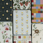 Springtide Kindle case featuring a floral design with yellow flowers on a striped background, surrounded by various patter...