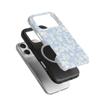 Spritz iPhone case featuring a light blue floral design, layered over black and clear cases.