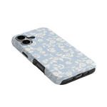 Spritz iPhone case featuring a light blue floral pattern with white flowers and a black edge, angled view.