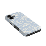Spritz iPhone case featuring a light blue floral pattern with white flowers and a black edge, angled view.