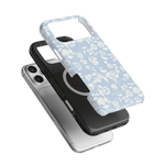 Spritz iPhone case featuring a light blue floral design, layered over a black and silver phone case.
