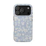 Spritz iPhone case featuring a light blue floral pattern with white flowers and a black camera cutout.