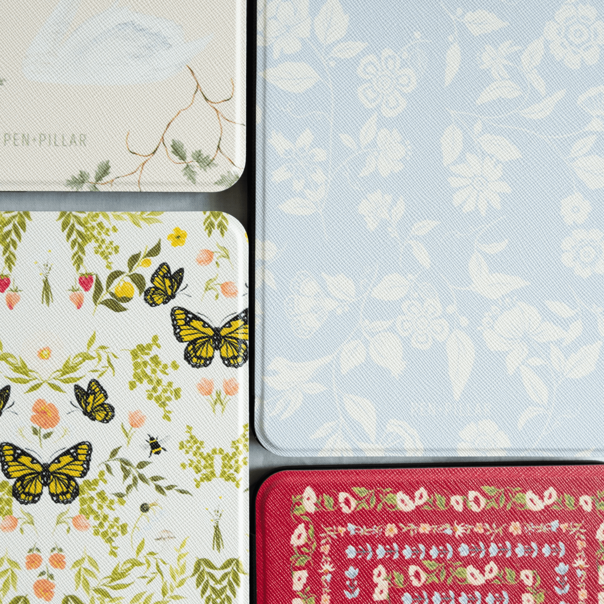 Spritz Kindle case featuring floral and butterfly patterns in various colors and textures on a textured background.