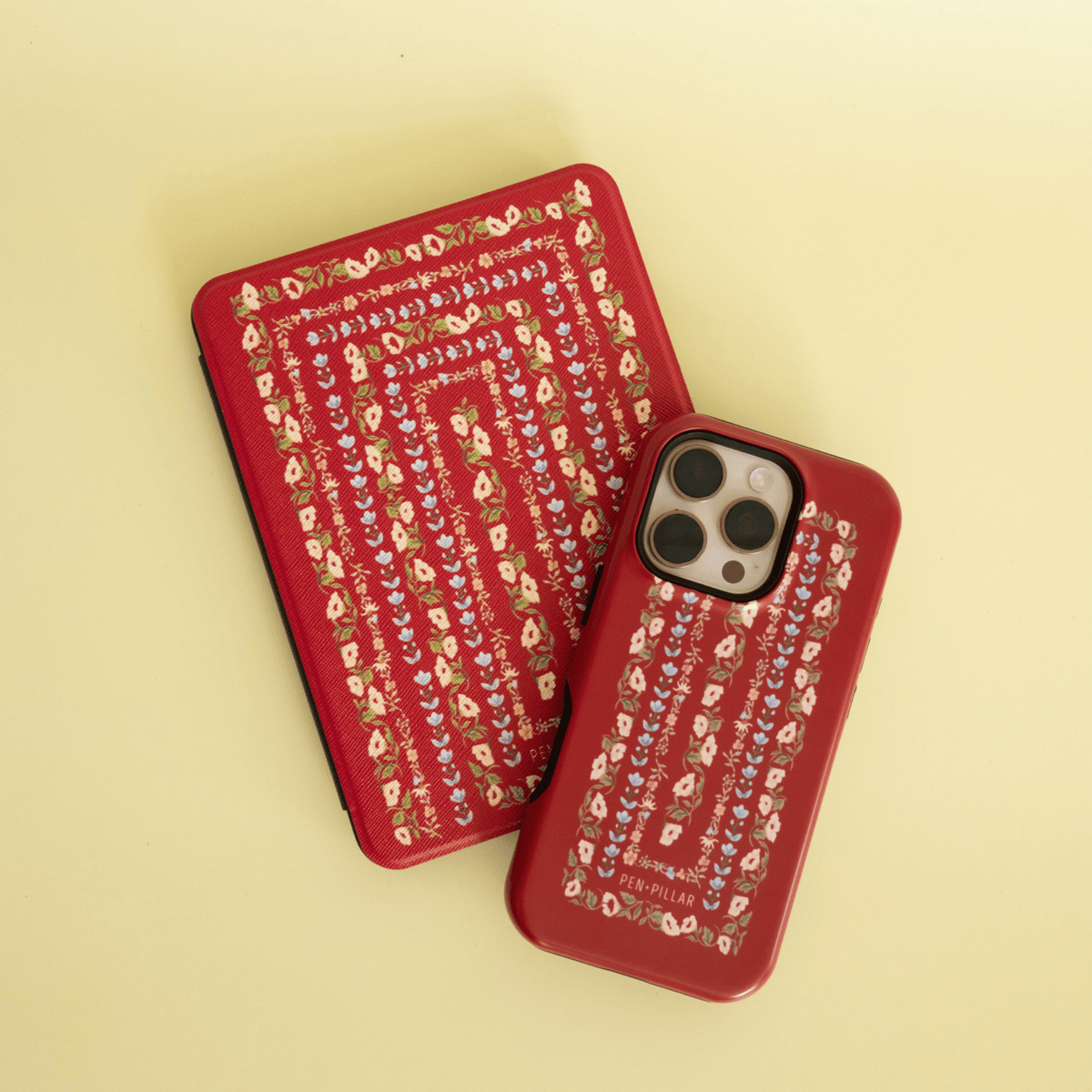 Fiona Kindle case and iPhone case, ornate red floral stripes, on a buttery yellow background
