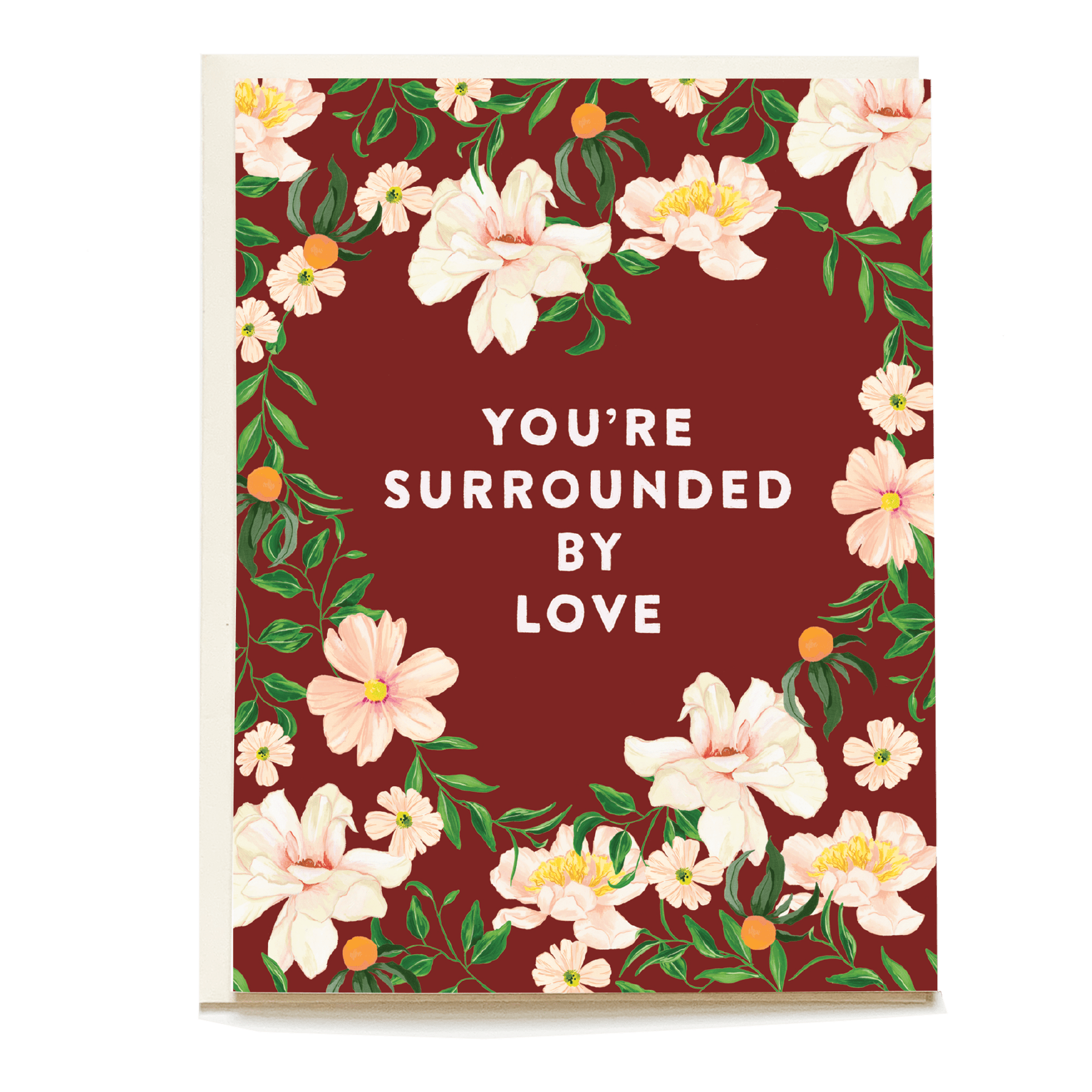 Sympathy card with floral design and the text "You're surrounded by love" on a burgundy background.