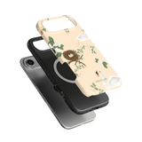 Swan Hollow iPhone case featuring a floral design with swans and a nest, shown in two angles on a green background.