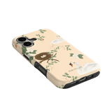 Swan Hollow iPhone case featuring swan illustrations, floral designs, and a nest on a light peach background.
