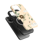 Swan Hollow iPhone case featuring a light beige background with swan and floral illustrations, layered over a black phone.
