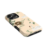 Swan Hollow iPhone case featuring swan illustrations and a nest design on a soft peach background.