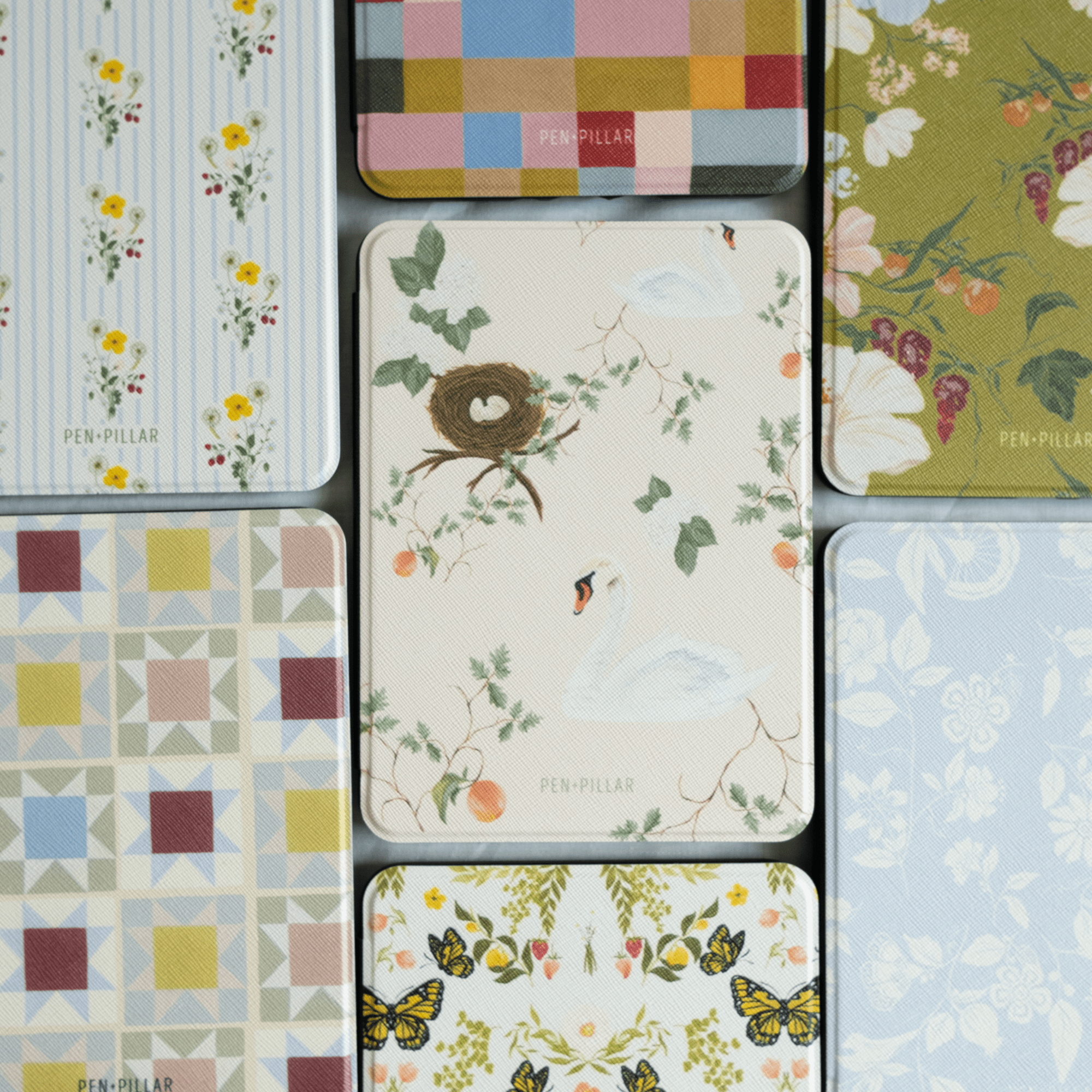 Swan Hollow Kindle case featuring a swan and nest design with floral accents on a light background.